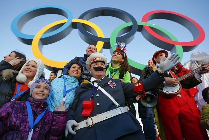 Fans cheer underneath the Olympic rings during the Sochi 2014 Winter Olympics Games, 8 February. Cheerful Lot