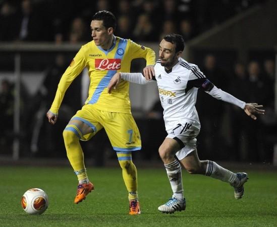 Swansea midfielder Leon Britton challenges Napoli forward Jose Callejon for the ball during their Europa League first leg game, 20 February. Reuters Callejon Napoli Britton Swansea
