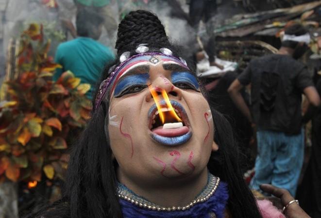 A man dressed as Hindu Lord Shiva performs with fire during a religious procession at the Mahashivratri festival in the northern Indian city of Allahabad A man dressed as Hindu Lord Shiva performs with fire during a religious procession at the Mahashivratri festival in the northern Indian city of Allahabad February 27, 2014.