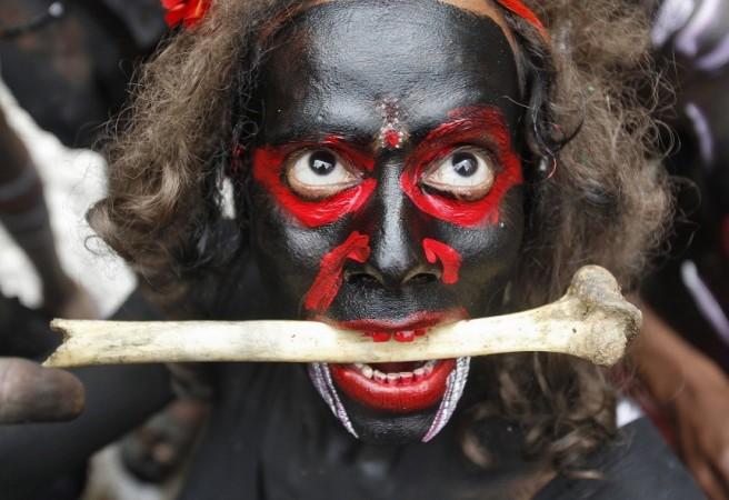 A man dressed as a demon performs with a bone during a religious procession at the Mahashivratri festival in the northern Indian city of Allahabad A man dressed as a demon performs with a bone during a religious procession at the Mahashivratri festival in the northern Indian city of Allahabad February 27, 2014.