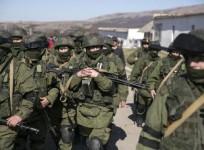 military-personnel-believed-to-be-russian-servicemen-walk-outside-the-territory-of-a-ukrainian-military-unit-in-the-village-of-perevalnoye-outside-simferopol