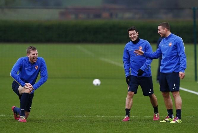 Germany players Per Mertesacker, Mesut Ozil and Lukas Podolski share a laugh during a training session with Arsenal, 18 February. Reuters Mertesacker Ozil Podolski Arsenal