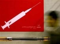 a-man-walks-past-a-poster-at-a-conceptual-art-exhibition-about-hiv-aids-reuters-files