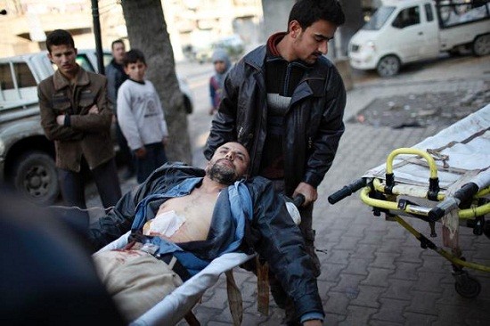 Free Syrian Army fighters carry their wounded comrade who was shot during a fight/Reuters File