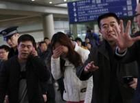 a-relative-of-a-passenger-onboard-malaysia-airlines-flight-mh370-covers-her-face-as-she-cries-at-the-beijing-capital-international-airport-in-beijing-march-8-2014