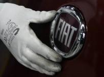 a-worker-adjusts-the-logo-on-a-new-fiat-punto-at-a-fiat-factory-assembly-line-in-the-central-serbian-town-of-kragujevac