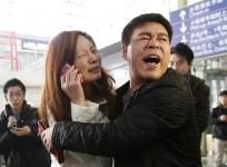 a-relative-woman-in-white-of-a-passenger-onboard-malaysia-airlines-flight-mh370-cries-as-she-talks-on-her-mobile-phone-at-the-beijing-capital-international-airport-on-8-march-2014