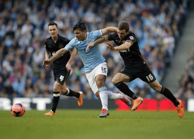 Manchester City striker Sergio Aguero is challenged by Wigan midfielder James McArthur during their FA Cup quarterfinal, 9 March. Sergio Aguero Manchester City James McArthur Wigan