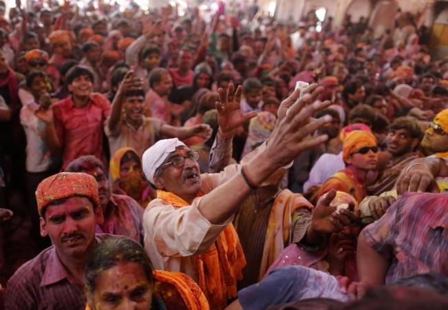 Hindu devotees gather at the Radhe-Krishna temple to celebrate Lathmar Holi