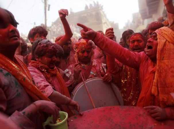 Hindu devotees sing religious songs as they celebrate Lathmar Holi