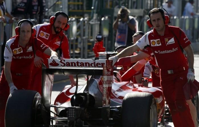 Mechanics push Kimi Raikkonen's Ferrari into the pits during a practice session at the Australian GP, 14 March. Reuters Ferrari Raikkonen F1