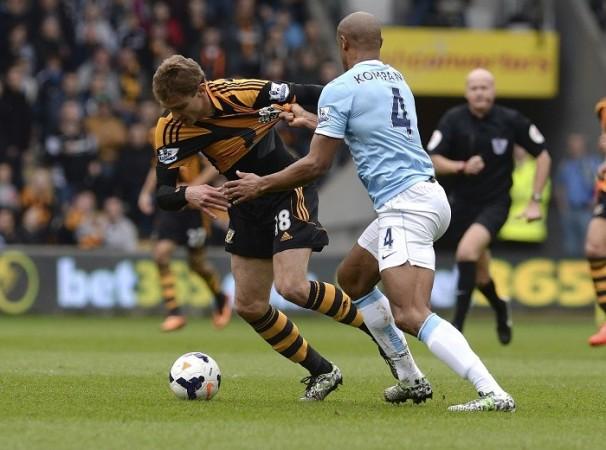 Manchester City skipper Vincent Kompany brings down Hull City striker Nikica Jelavic in their English Premier League game, 15 March. Reuters Kompany Manchester City Jelavic Hull City