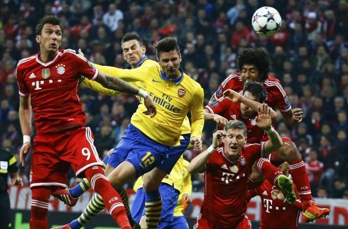 Arsenal striker Olivier Giroud and Bayern Munich forward Mario Mandzukic go up for a header in their Champions League last 16 tie, 11 March. Reuters Giroud Mandzukic Arsenal Bayern Munich