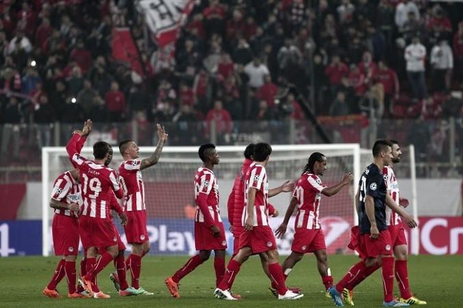 Olympiakos players celebrate their first leg win over Manchester United in the Champions League, 25 February. Reuters Olympiakos