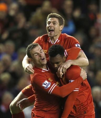 Liverpool's Daniel Sturridge (R) celebrates with teammates Steven Gerrard (C) and Jordan Henderson after scoring a goal during their English Premier League soccer match against Sunderland at Anfield in Liverpool, northern England March 26, 2014. Exalted Liverpool