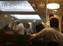Customers wait their turn to be served at the Air Canada's office in Caracas