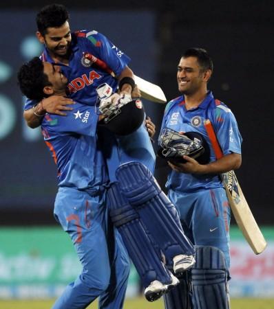 Yuvraj Singh lifts Virat Kohli off the ground as Dhoni looks on after India's brilliant win over South Africa in the ICC World T20 semifinal, 4 April. Reuters Virat Kohli Yuvraj Dhoni India