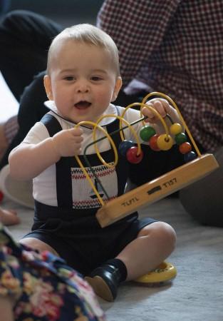 Prince George, son of Britain's Prince William and his wife Catherine, the Duchess of Cambridge, plays with a toy during a Plunket nurse and parents group event at the Government House in Wellington April 9, 2014. The Royal New Zealand Plunket Society, or Plunket for short, is a national not-for-profit organisation that provides care for children and families in New Zealand. Britain's Prince William and his wife Kate are undertaking a 19-day official visit to New Zealand and Australia with their son George. Prince George