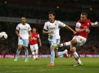 podolski-arsenal-tomkins-west-ham