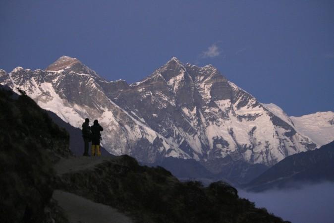 Travellers enjoy a view of Mount Everest at Syangboche in Nepal, in this December 3, 2009 file photograph. REUTERS/Gopal Chitrakar/Files