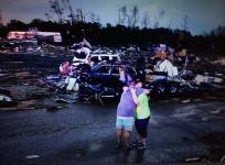 lori-berseth-is-consoled-after-searching-for-her-missing-black-labrador-dog-lucille-after-a-tornado-destroyed-the-town-of-mayflower-photo-reuters