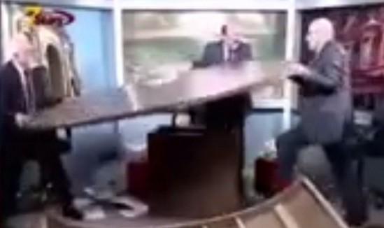 Within minutes into the show, Shaker al-Jawhary (right) grew furious and launched himself at Mohammad Sharif al-Jaiousy (YouTube) Within minutes into the show, Shaker al-Jawhary (right) grew furious and launched himself at Mohammad Sharif al-Jaiousy (YouTube)