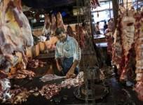 A butcher cuts up portions of beef for sale in an abattoir at a wholesale market in Mumbai (Reuters)