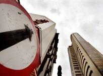 A road sign stands next to the Bombay Stock Exchange building (Reuters)