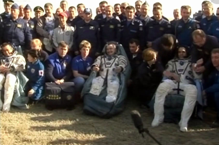 The Expedition 39 crew adjusts to the full force of Earth's gravity shortly after landing in Kazakhstan aboard their Soyuz spacecraft. (NASA TV)