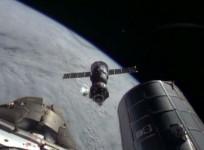 The Soyuz TMA-11M spacecraft backs away from the International Space Station shortly after undocking. (NASA TV)