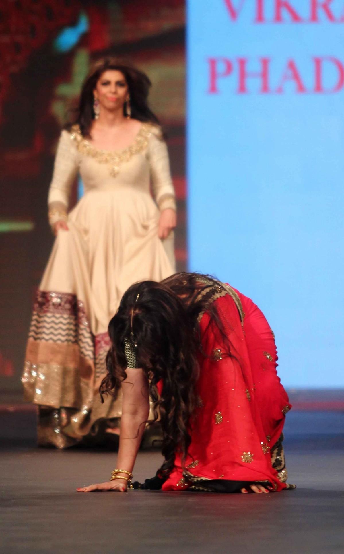 Poonam Dhillon falls down while walking the ramp for 'Caring with Style' fashion show. Poonam Dhillon