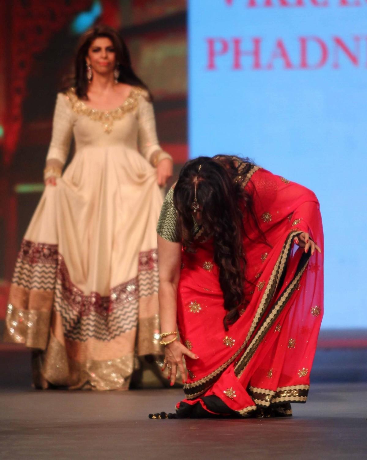 Poonam Dhillon tries to get up after the fall during the 'Caring with Style' fashion show. Poonam Dhillon