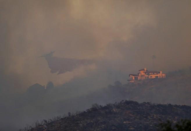 San Diego Wildfire: A water bomber makes a drop as a wildfire near San Diego moves up a hillside near San Marcos San Diego Wildfire