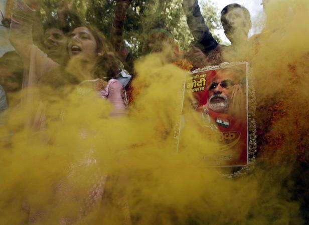Supporters of India's BJP hold a portrait of Hindu nationalist Modi during celebrations in New Delhi