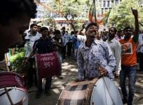 Supporters of the Bharatiya Janata Party (BJP) celebrate after learning of initial poll results outside their party office in Mumbai