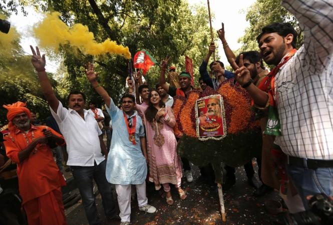Supporters of India's BJP hold a portrait of Hindu nationalist Modi during the celebrations in New Delhi