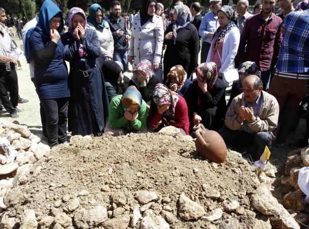 People mourn during the funeral of a miner who died in a fire at a coal mine, at a cemetery in Soma, a district in Turkey's western province of Manisa