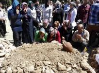 People mourn during the funeral of a miner who died in a fire at a coal mine, at a cemetery in Soma, a district in Turkey's western province of Manisa