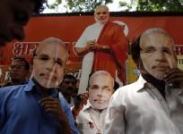 Hindu nationalist Modi, prime ministerial candidate for India's main opposition BJP, gestures as he arrives to seek blessings from his mother Heeraben at her residence in Gandhinagar