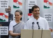 Congress party vice-president Rahul speaks to the media as his mother and chief of Congress Sonia looks on during a news conference in New Delhi