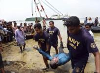 Members of the Bangladesh Navy recover the body of a passenger from the capsized M.V. Miraj 4 ferry by the Meghna river at Rasulpur in Munshiganj district