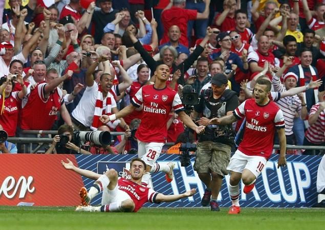 Arsenal's Aaron Ramsey celebrates with teammates Kieran Gibbs and Jack Wilshere after scoring the winner against Hull City. Aarom Ramsey