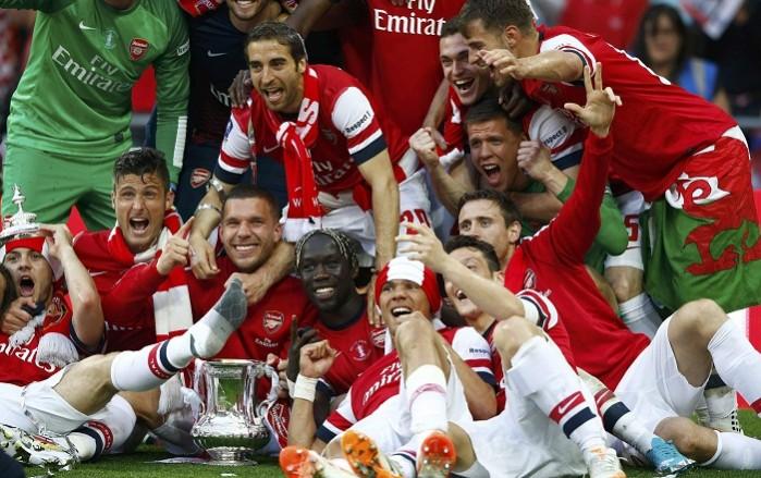 Arsenal's players celebrate with the trophy at the Wembley stadium. Arsenal team
