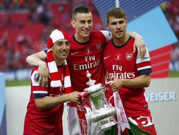 Arsenal's three goalscorers Cazorla , Koscielny and Ramsey pose with the FA Cup. Arsenal players