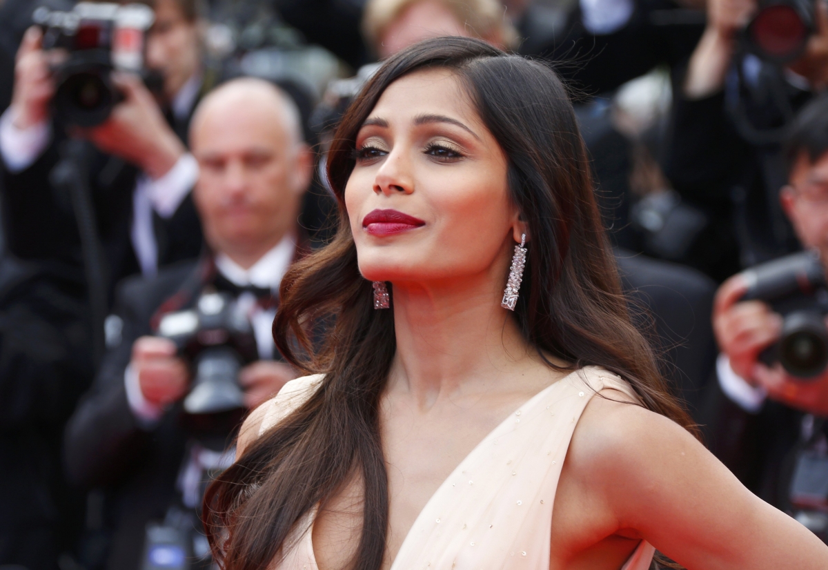 Actress Freida Pinto poses on the red carpet as she arrives for the screening of the film Freida Pinto