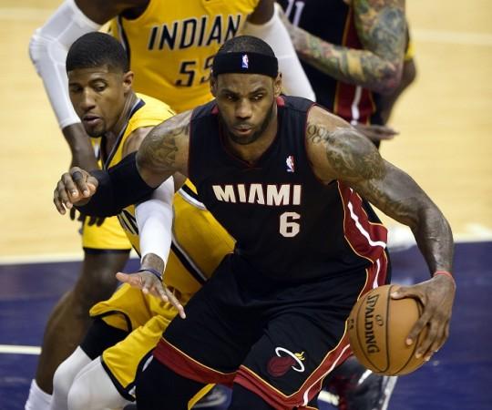 Miami Heat's LeBron James spins to get away from the Indiana Pacers' Paul George. LeBron James