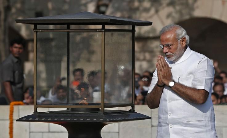 Indian Prime Minister-designate Modi walks at the Mahatma Gandhi memorial after paying the flower tribute at Rajghat ahead of his swearing-in ceremony, in New Delhi Modi's swearing-in ceremony, in New Delhi