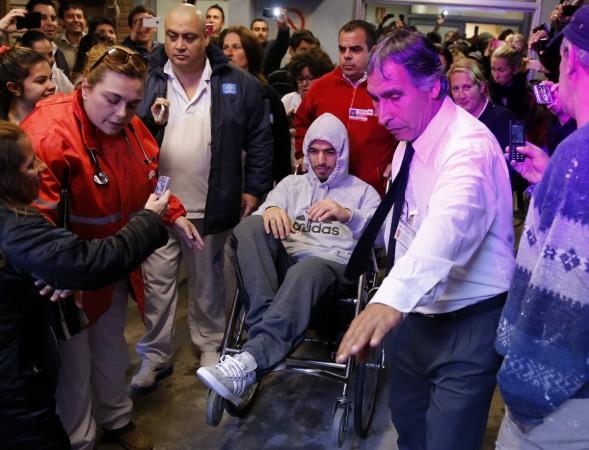 Uruguay striker Luis Suarez leaves the hospital in a wheelchair after surgery in Montevideo Suarez