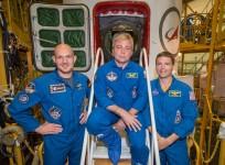 At the Baikonur Cosmodrome in Kazakhstan, Expedition 40 Flight Engineers Alexander Gerst (left), Maxim Suraev (center) and Reid Wiseman pose for pictures in front of their Soyuz TMA-13M spacecraft. (NASA/Victor Zelentsov)