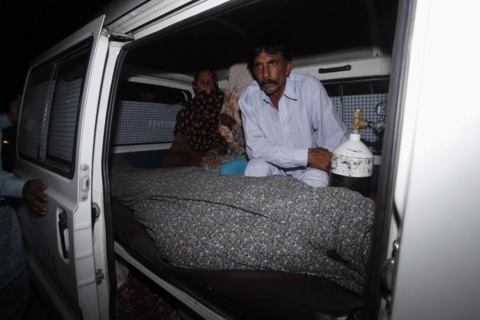 Mohammad Iqbal sits next to his wife Farzana's body in an ambulance outside of a morgue in Lahore Mohammad Iqbal sits next to his wife Farzana's body, who was killed by family members, in an ambulance outside of a morgue in Lahore